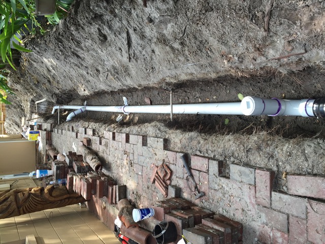 Open trench revealing a sewer line section that was located via camera inspection