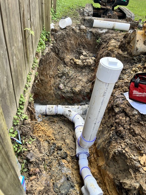Narrow access pit used as the entry point for a trenchless water line replacement