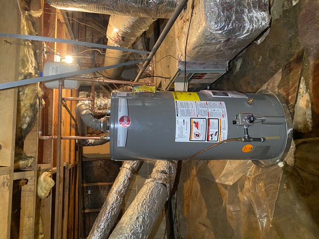 Newly installed Rheem gas water heater with proper venting and shutoffs